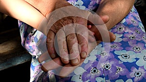 Senior woman wrinkled hands hold kid hand. Closeup hands of grandmother