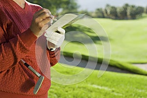 Senior Woman Writing Golf Score