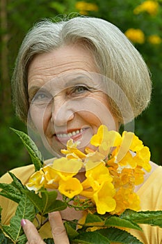 Senior woman with yellow flowers