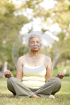 Senior Woman Yoga In Park