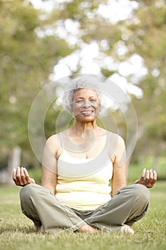 Senior Woman Yoga In Park