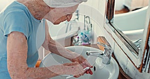 Senior women, brushing teeth and denture in bathroom for hygiene, wellness and health in morning. Elderly person, lady