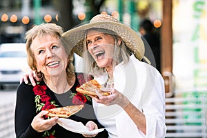 Senior Women Eating Street Food and Laughing