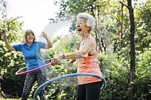 Senior woman exercising with a hula hoop photo