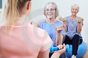 Senior Women At Fitness Class With Instructor