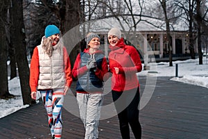 Senior Women Friends Strolling And Talking After Outdoors Training In Park. Active Lifestyle And Friendship at Middle Age. Active