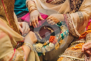 Senior women hands open velvet boxes with golden jewelry earrings