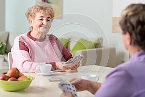 Senior women playing cards