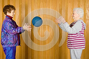 Senior women playing catch