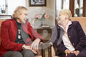 Senior women relaxing in armchairs