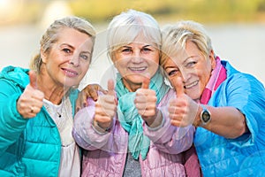 Senior women showing thumbs up