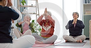Senior women, yoga group and coach in meditation, peace and prayer hands in exercise, holistic wellness and mindfulness