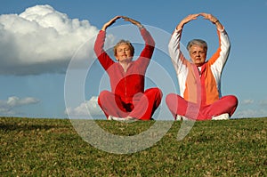 Senior women yoga outdoors