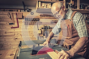 Senior woodworker with tablesaw photo