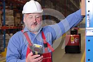 Senior worker with bar code reader