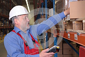 Senior worker with bar code reader