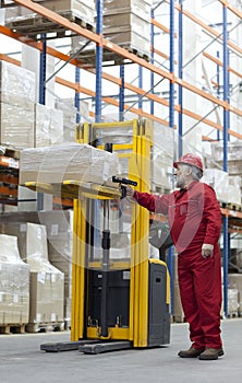 Senior worker with bar code reader in warehouse