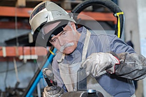 senior worker ready to weld