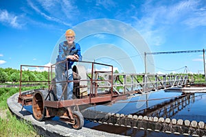 Senior worker standing on waste water treatment unit