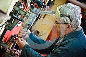 Senior workman portrait with drill