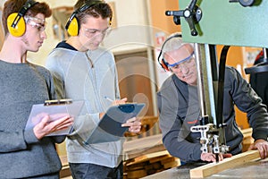 senior and young men - woodwork apprenticeship