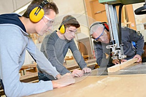 Senior and young men - woodwork apprenticeship photo