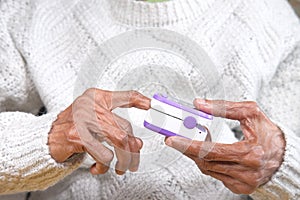 senior young women hand using pulse oximeter