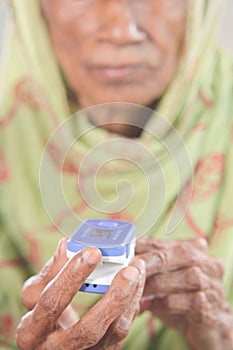 senior young women hand using pulse oximeter