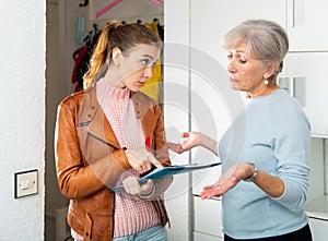 Senior and younger women discussing breach of rent contract