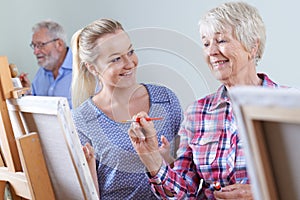 Seniors Attending Painting Class With Teacher