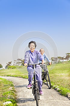 Seniors couple biking in the park