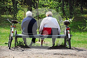 Seniors couple cyclists resting