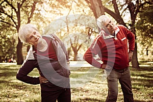 Seniors couple in sports clothing working stretching and