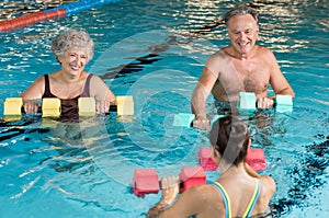 Seniors doing aqua aerobics photo