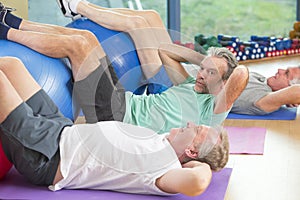 Seniors doing sit-ups at the gym