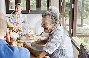 Seniors enjoying breakfast together in the hall