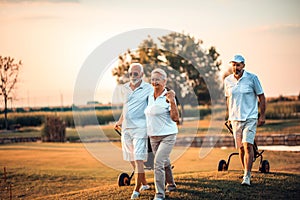 Seniors golfers having fun on golf field