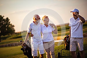 Seniors golfers having fun on golf field