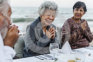 Seniors having a dinner party at the beach