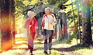 Seniors jogging on a forest road