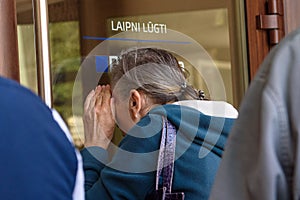 Seniors are looking into the window and trying to open doors at PNB Bank