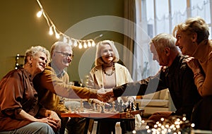 Seniors playing chess during meeting