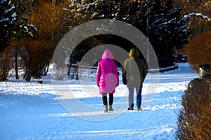 Seniors stroll through the park in winter