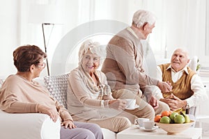 Seniors talking and drinking coffee photo
