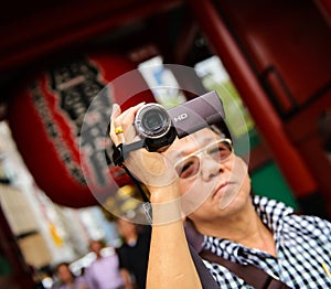 Seniors tourist holding a video camera