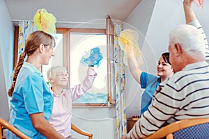 Seniors training fitness and coordination with gymnastics in nursing home