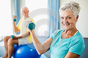 Seniors using exercise ball and weights