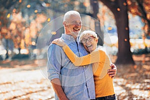 Seniors on a walk in autumn forest