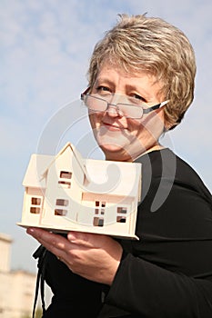 Senoir woman with house