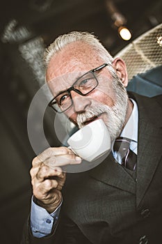 Senor businessman drinking coffee. Relax time photo